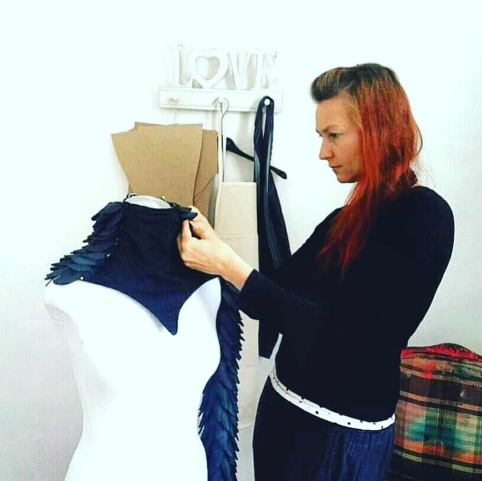 Tatum Kelly refining an intricate garment directly on a dress form